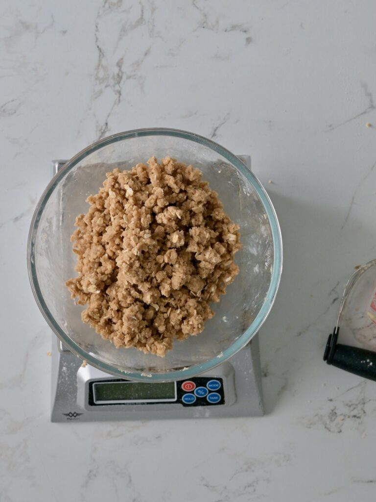 Moist Crumbs for the applesauce cake crumb topping in a bowl on a scale.