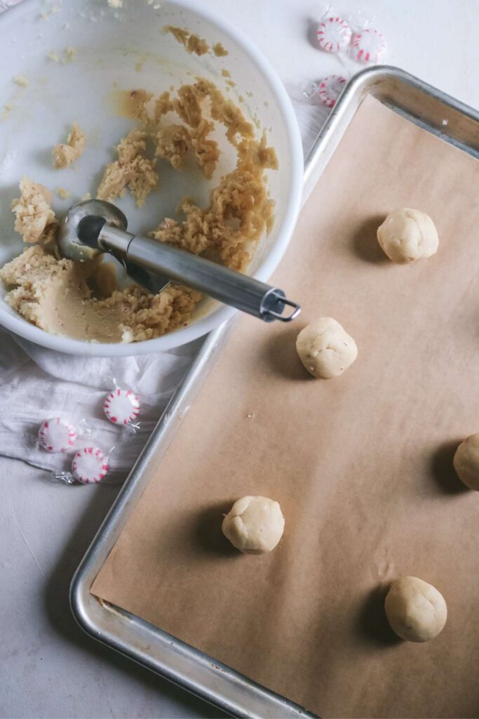 rolling peppermint sugar cookie dough into balls.