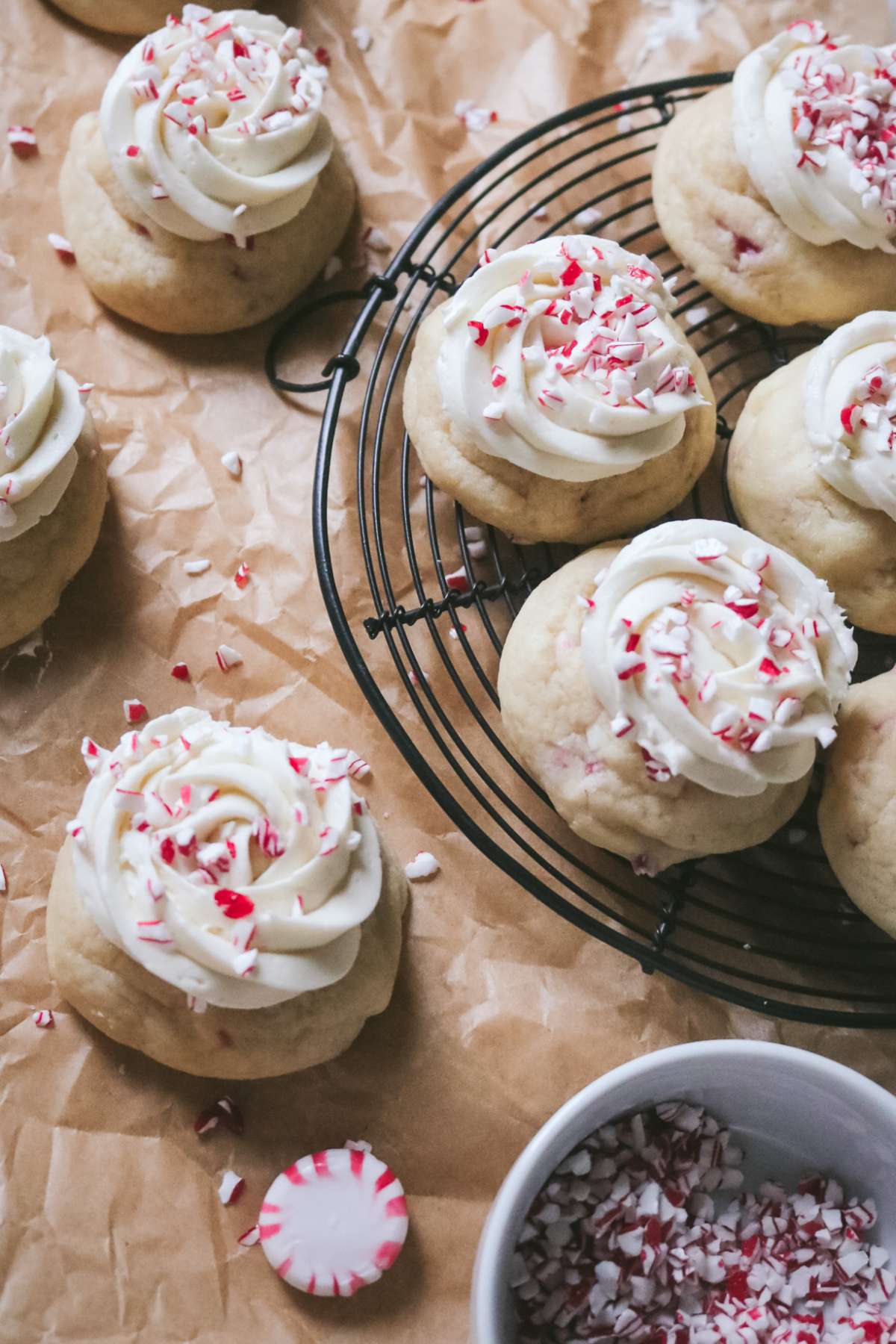 overhead view of a wire rack with peppermint sugar cookies topped with crushed candy cane pieces.