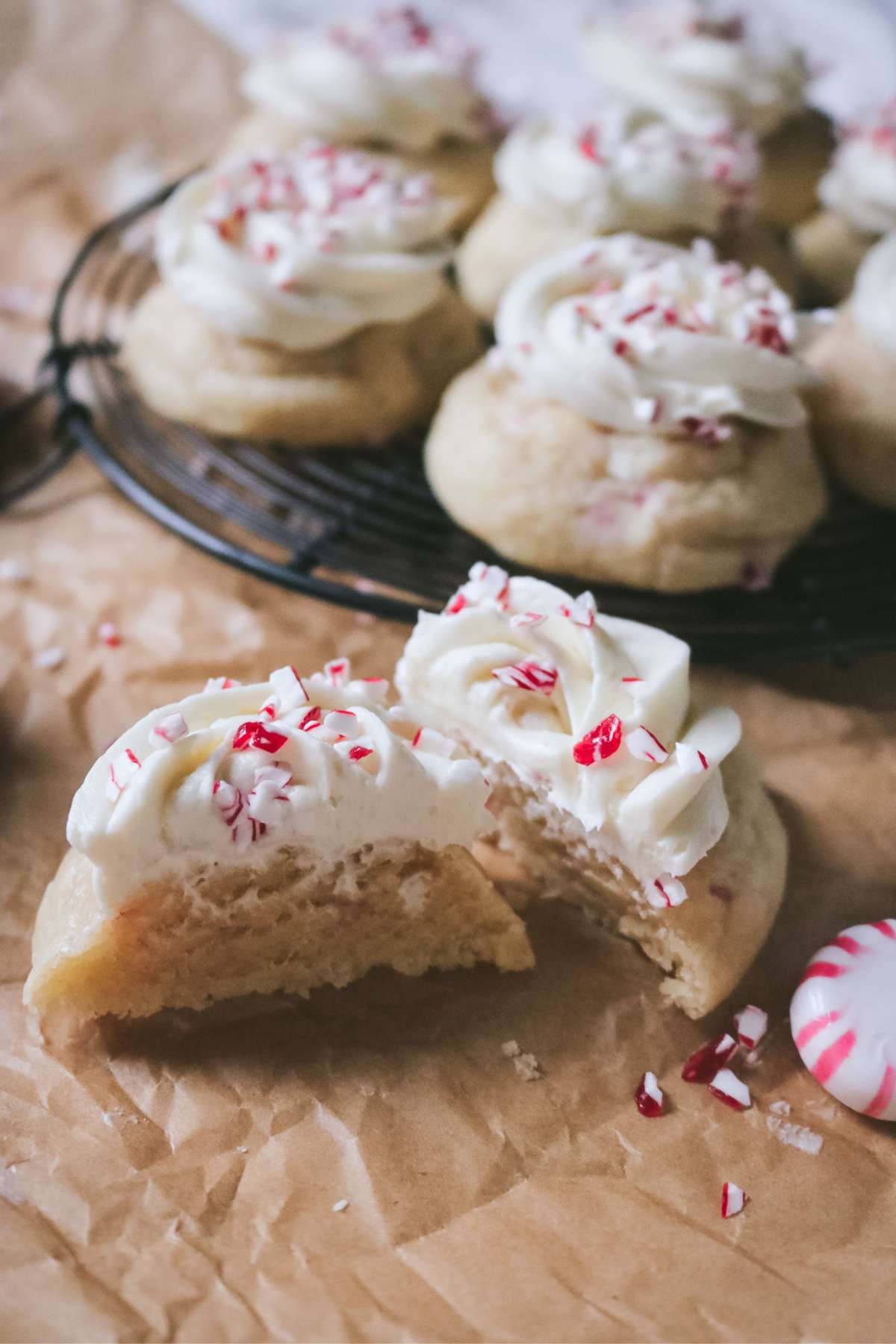 close up of a sliced frosted peppermint sugar cookie to show how soft it is on the inside.