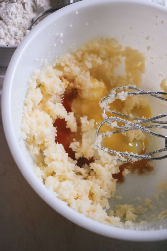 adding extracts and egg to cookie dough.