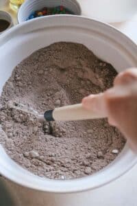 whisking brownie mixes, instant clearjel, and dry ingredients in a large mixing bowl.