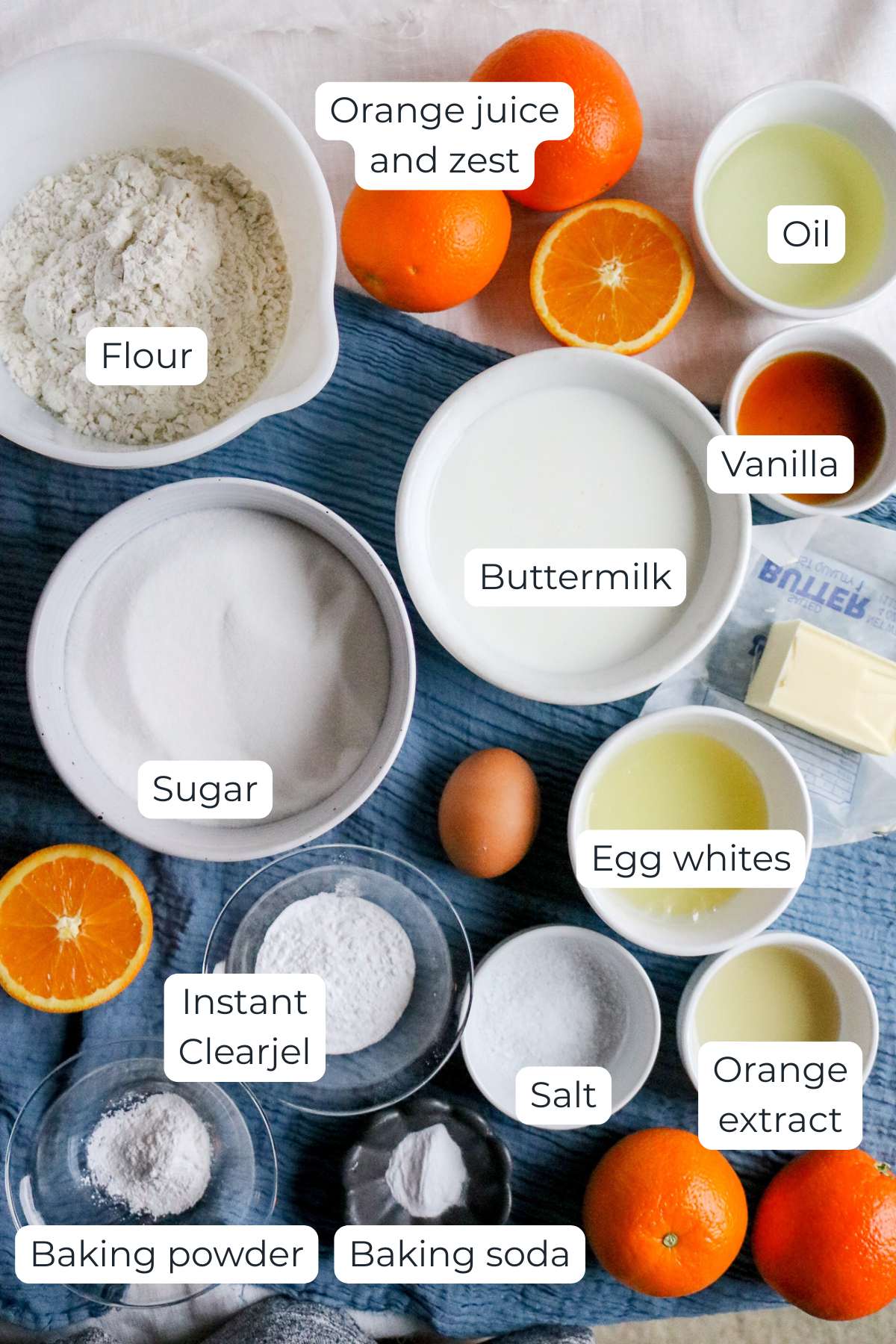 overhead view of the ingredients to make orange cupcakes from scratch including buttermilk, vegetable oil, and instant clearjel.