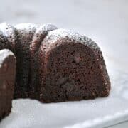 Cross section of a chocolate bundt cake showing ultra-moist chocolate crumb and pockets of chocolate chips.